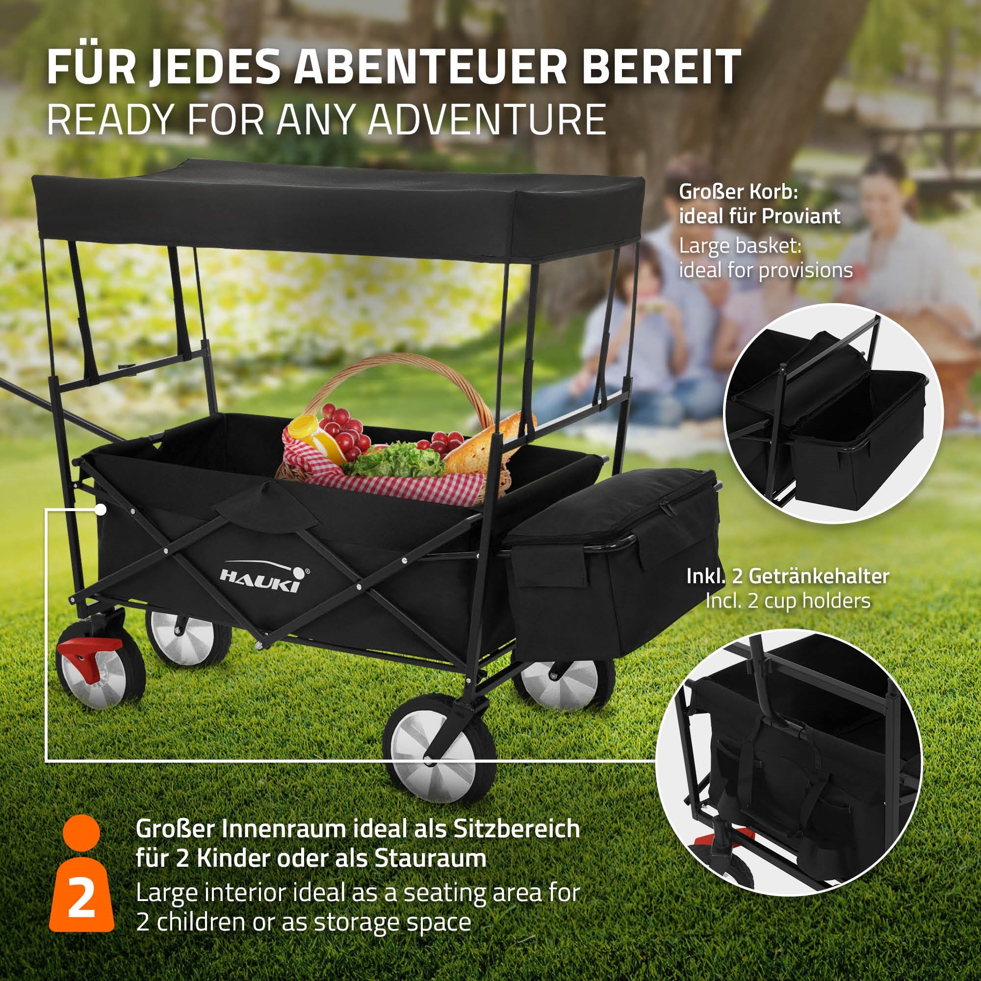Schwarzer Wagen mit Obst und Getränken auf einer Wiese.