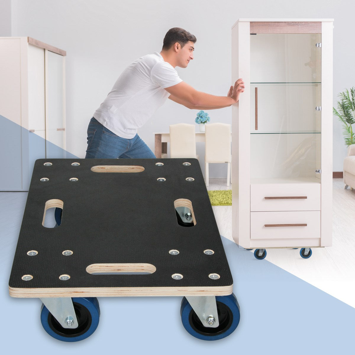 A man pushes a trolley carrying a piece of furniture.