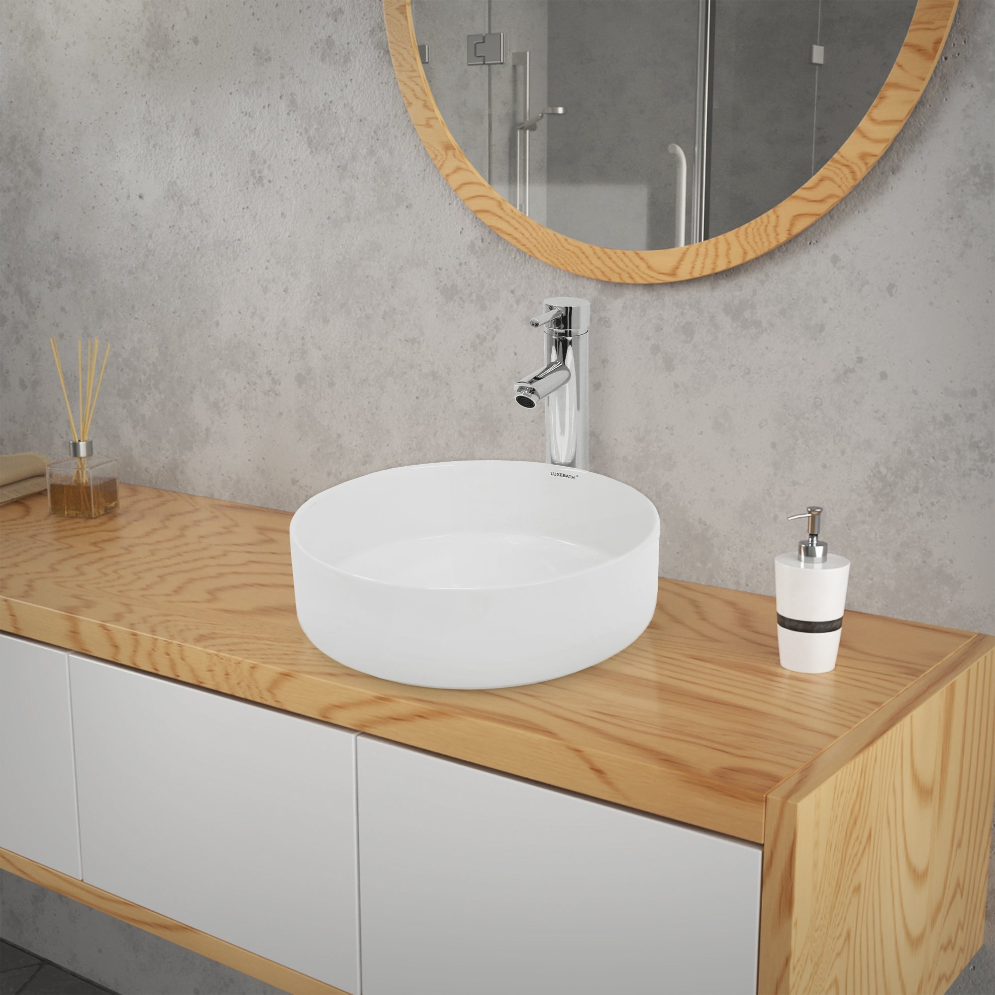 Round, transparent sink on a wooden shelf.