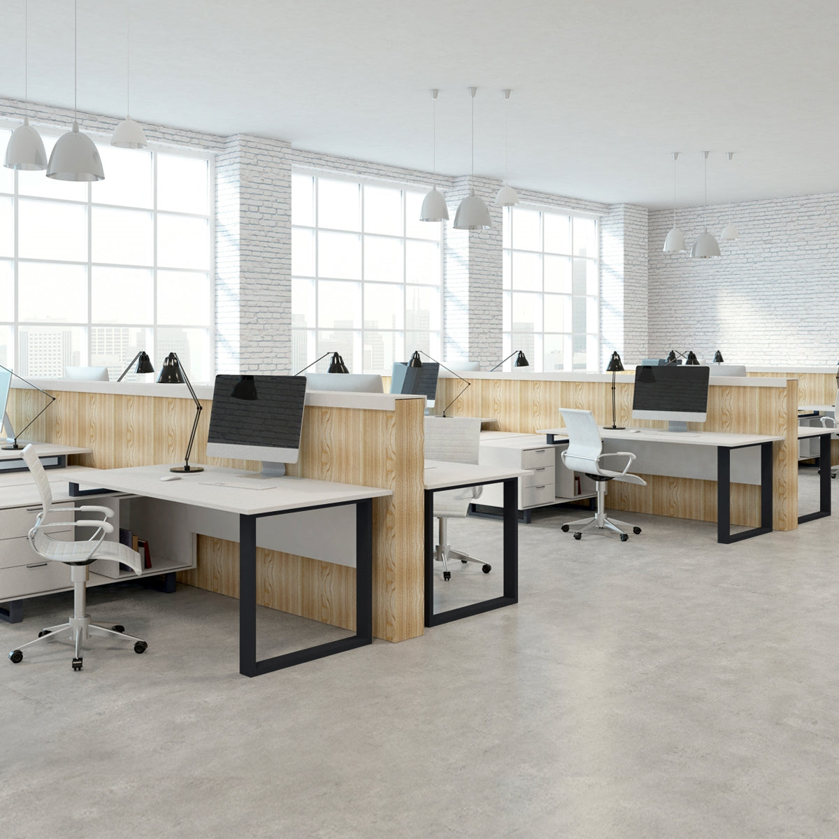 Büro mit mehreren Arbeitsplätzen, Tischen und Monitoren in einem hellen Raum.