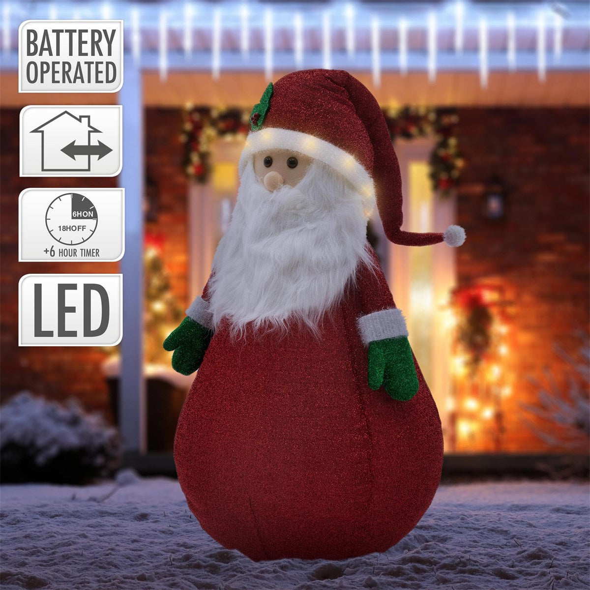 Ein Weihnachtsmann mit LED-Beleuchtung, der vor einem festlich geschmückten Haus steht.