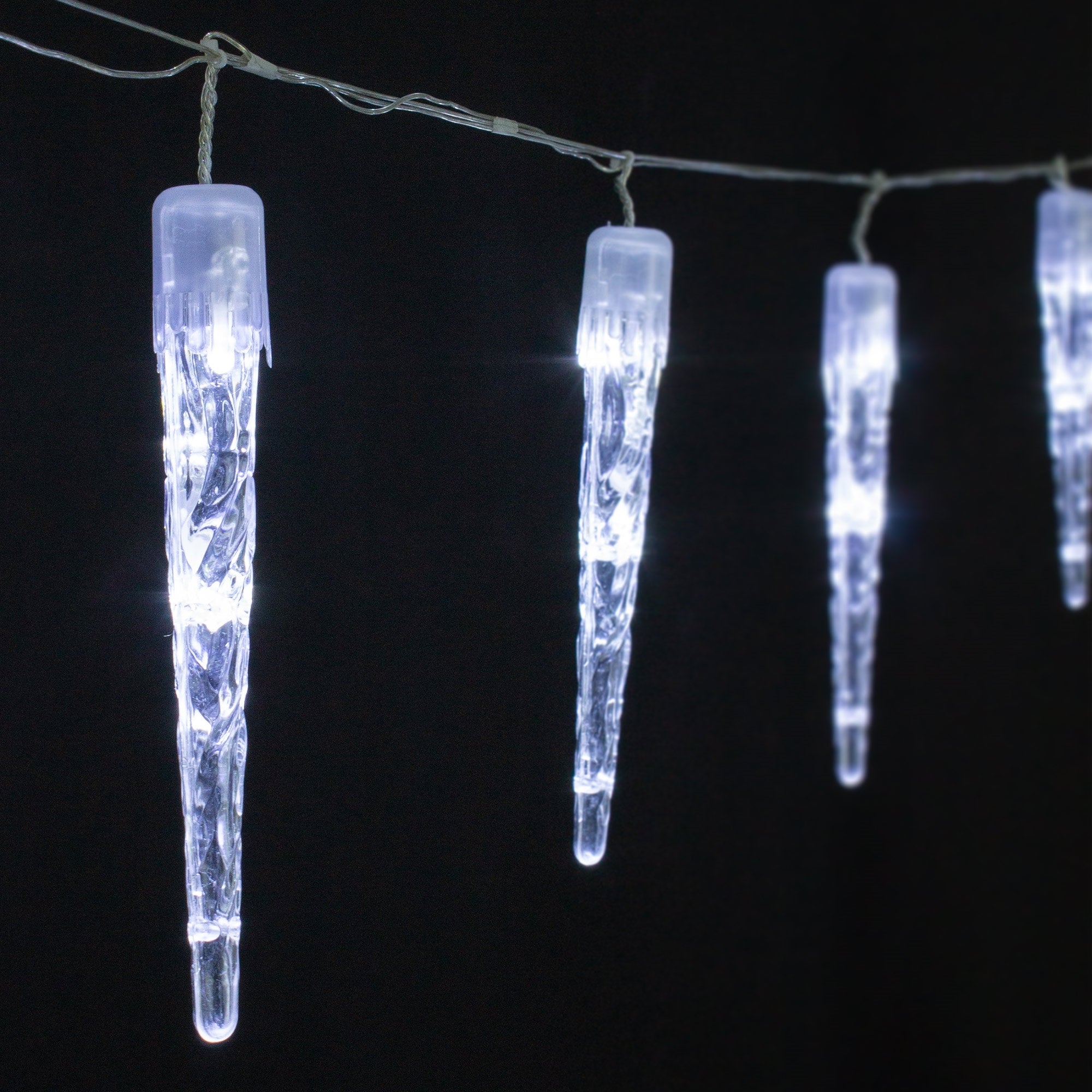 String lights with icicle-shaped, glowing elements on a black background.