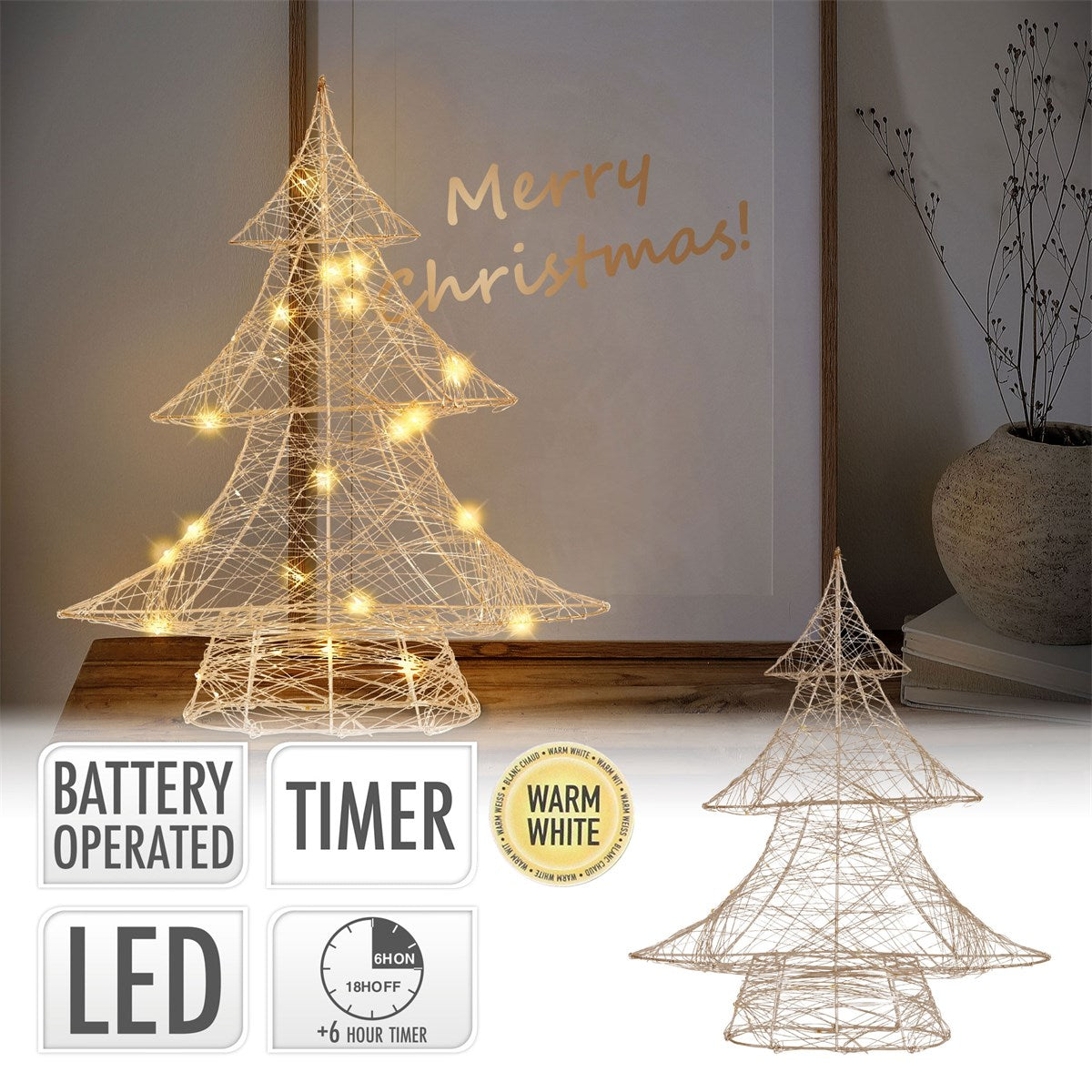 An illuminated Christmas tree stands next to a picture with the words 'Merry Christmas'.