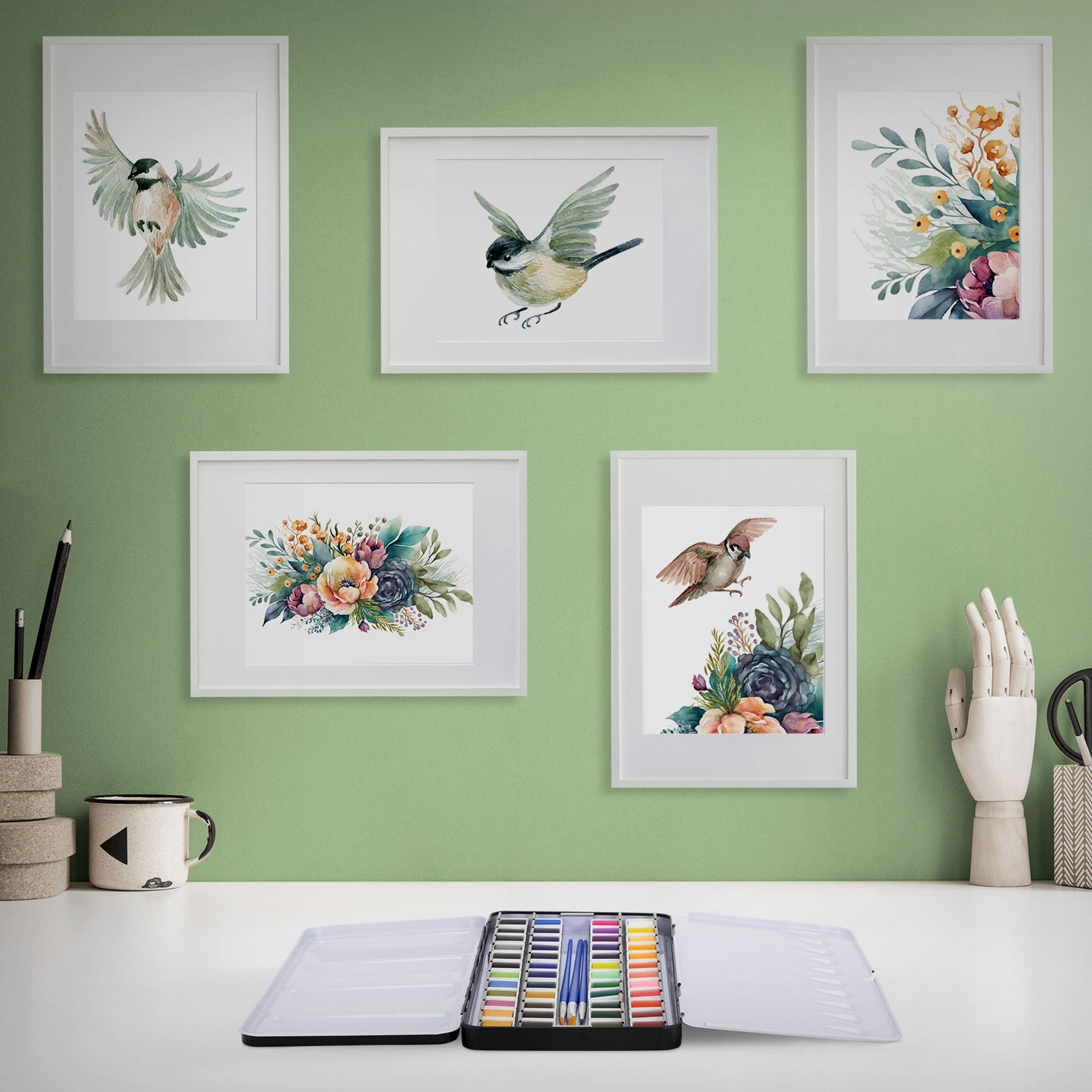 Wall with framed watercolor paintings and a color palette.