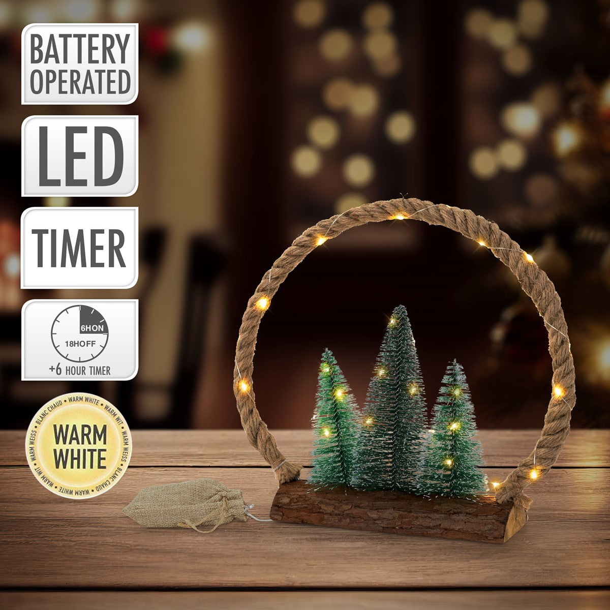 Ein dekorativer Baum mit Lichtern in einem Holzrahmen auf einem Tisch.