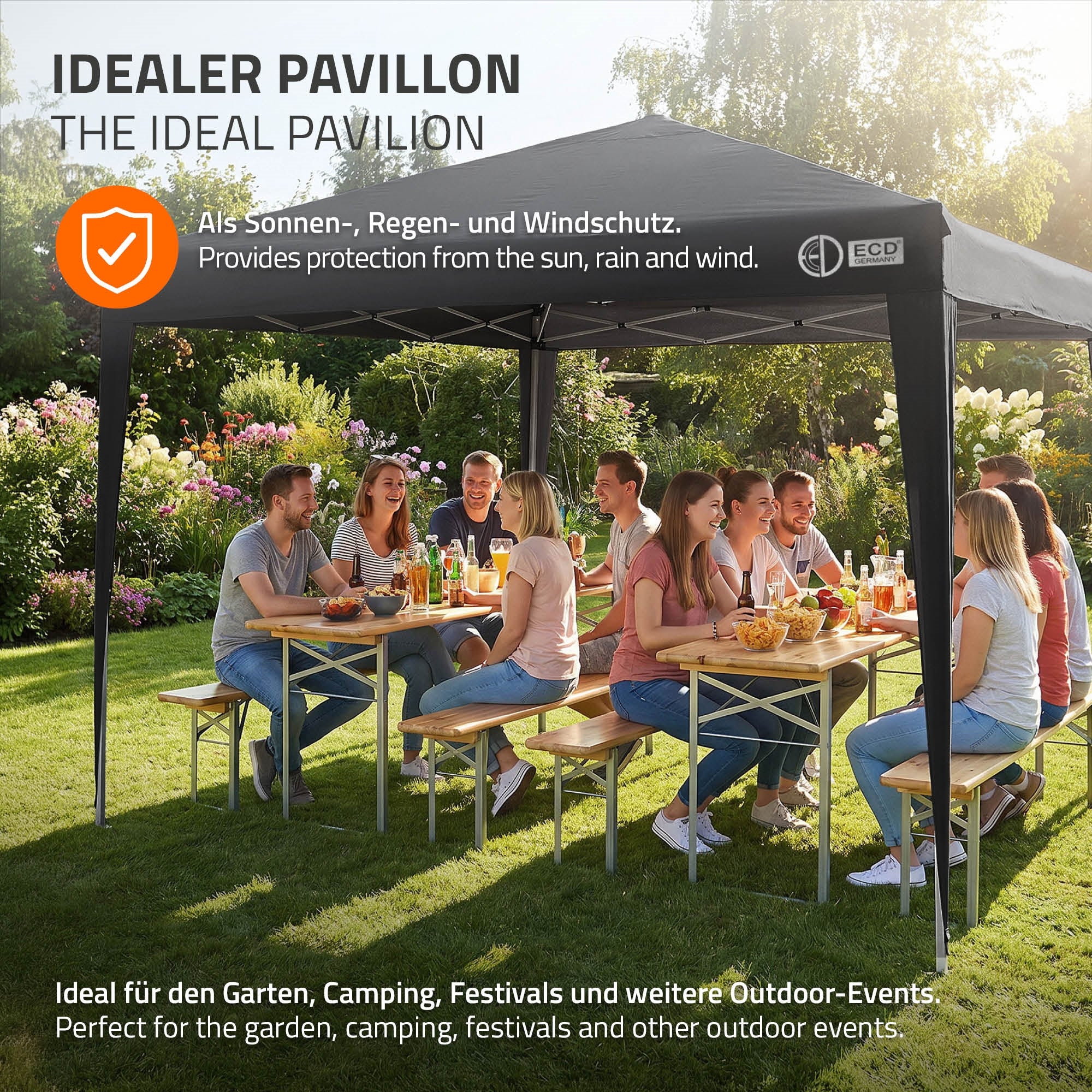 People enjoying a meal under a pavilion outdoors, surrounded by plants.