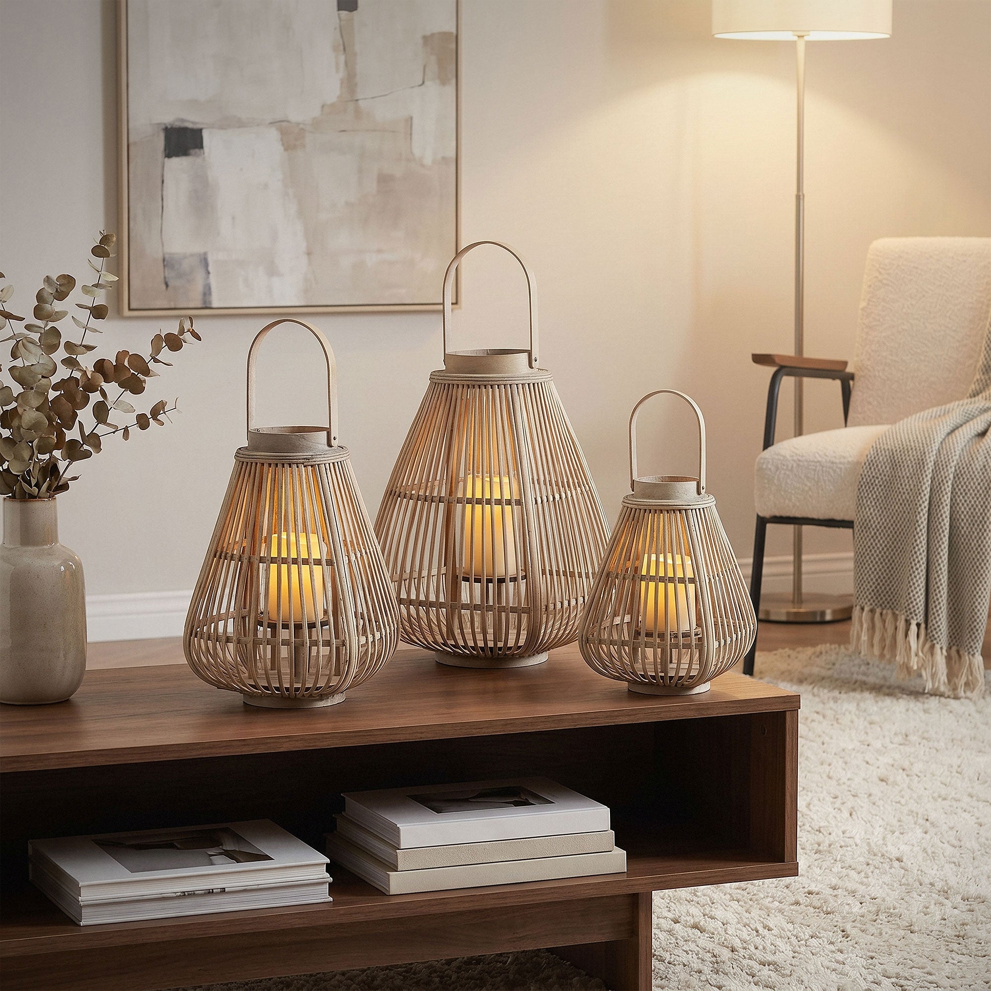 Three bamboo lanterns on a table in a modern living room.