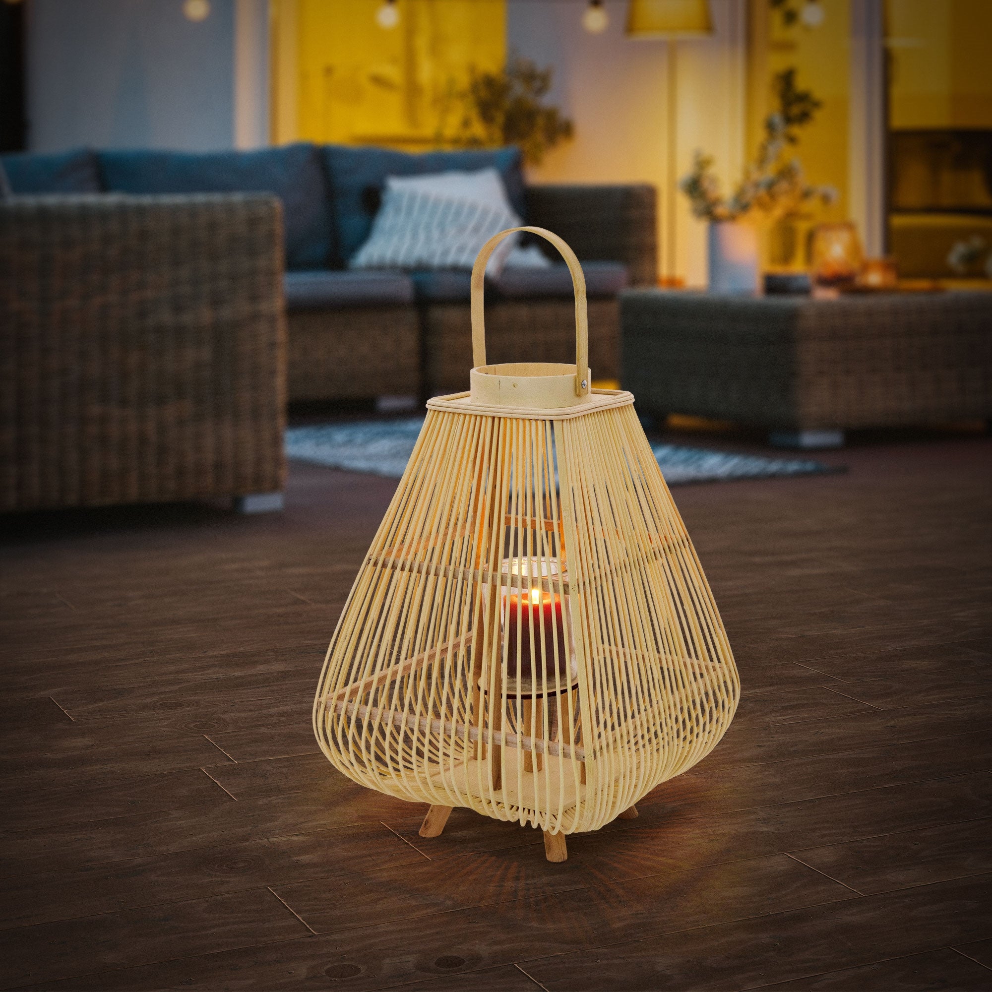 Single bamboo lantern on a dark floor in an outdoor area.