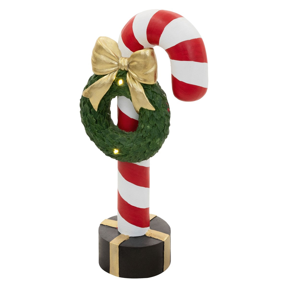 Ein rot-weißer Zuckerstangen-Ständer mit einer grünen Kranzdekoration und einer goldenen Schleife.