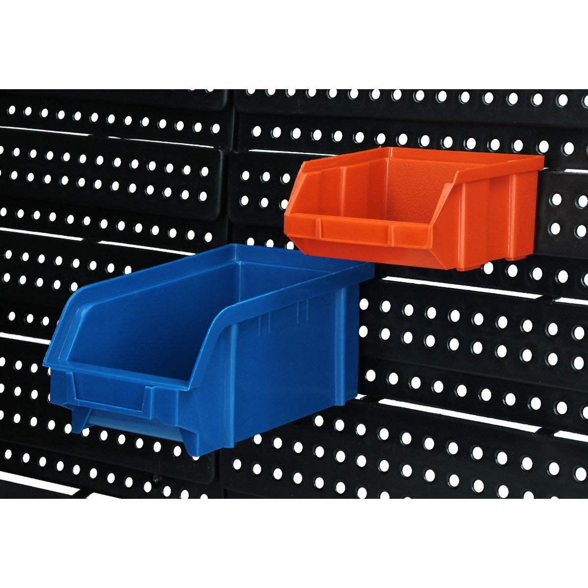 Blue and orange storage boxes on a perforated wall.