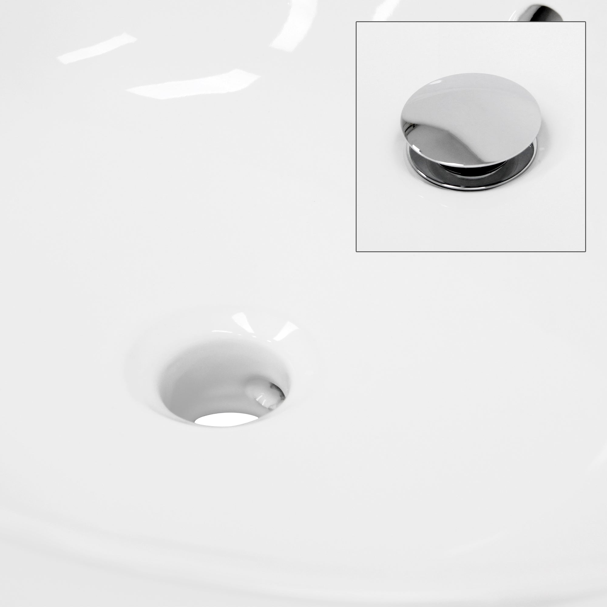 Close-up of a drain hole in a white washbowl.