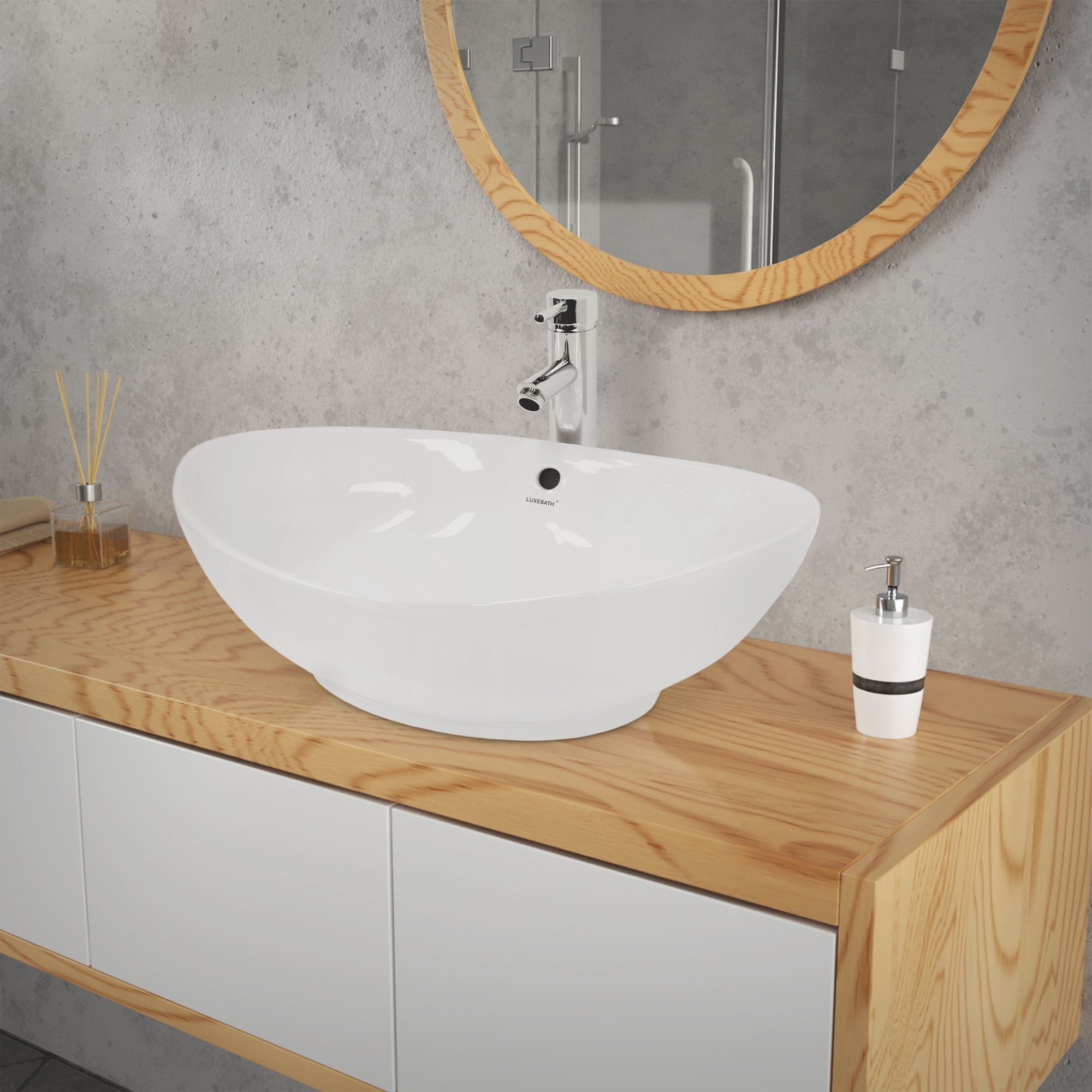 White washbowl on a wooden washstand in front of a mirror.