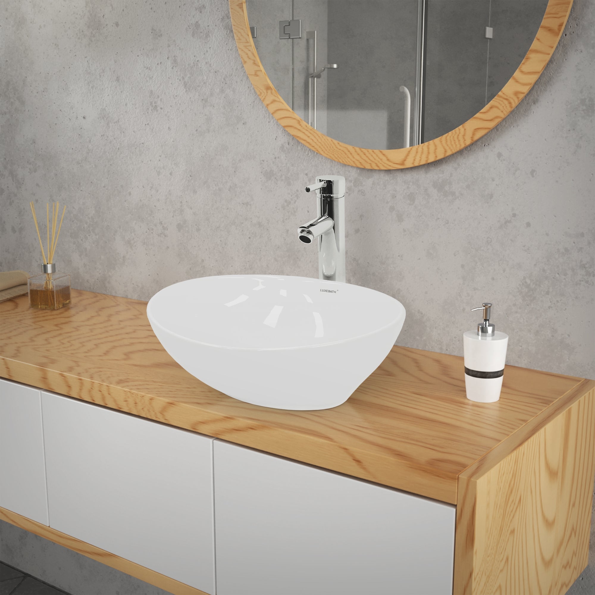 Washbasin made of white material on a wooden cabinet in front of a mirror.