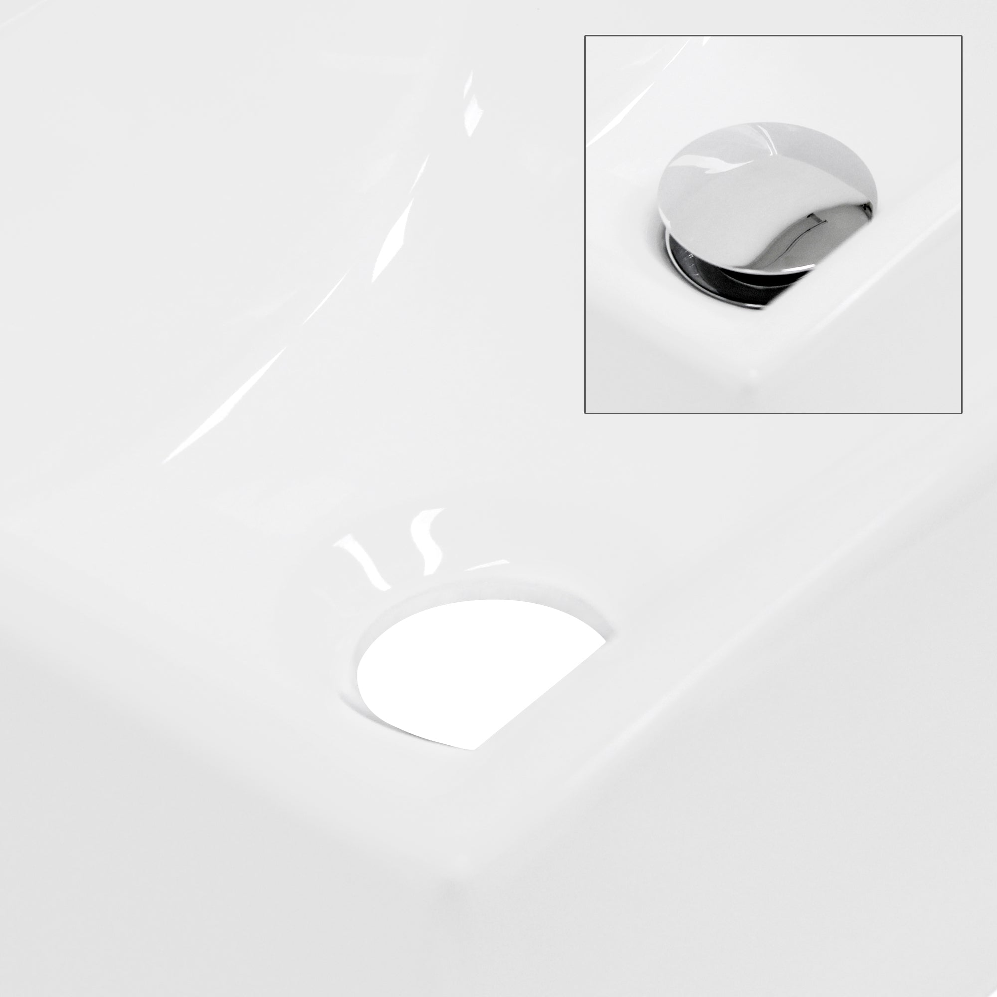 Close-up of a white sink with a drain hole.