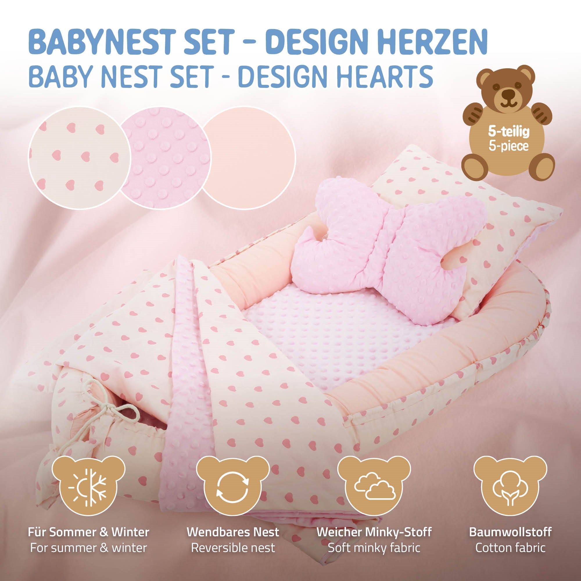 Ensemble de nid pour bébé en rose avec des cœurs et coussin en forme de papillon.