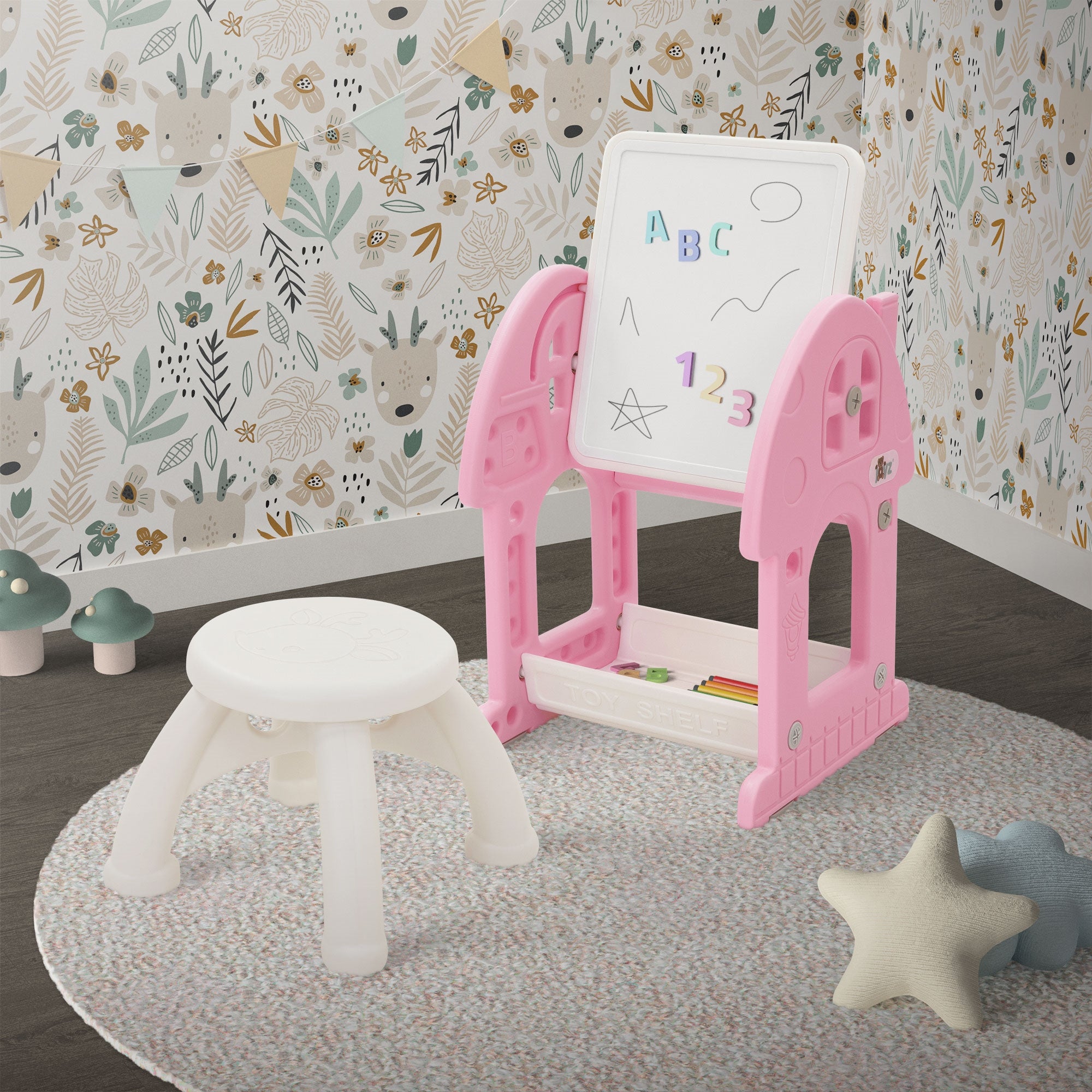 Ein pinker Spieltisch mit einer Tafel, einem Hocker und einer bunten Wanddekoration.