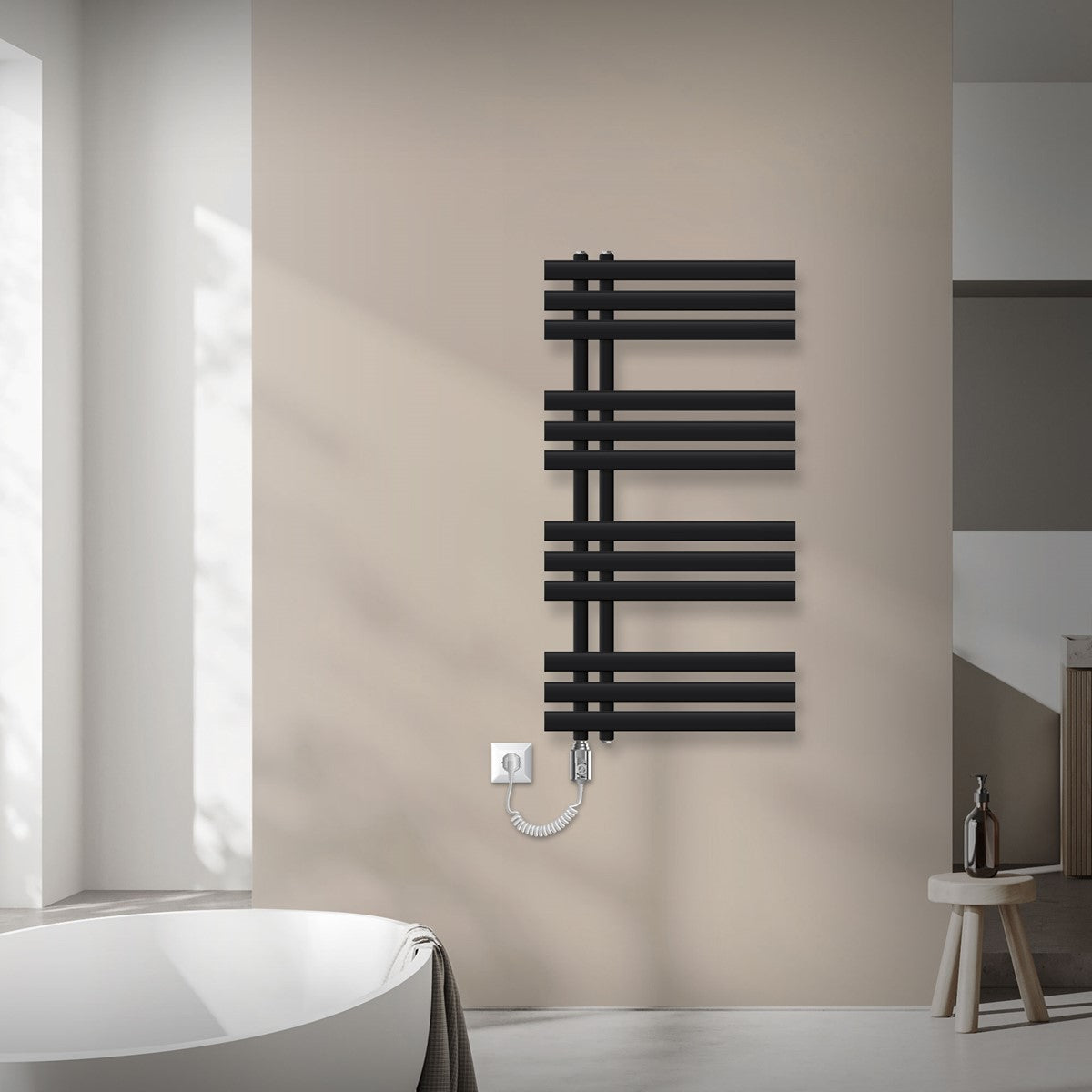 Black radiator on a wall with a power socket and towel rail.
