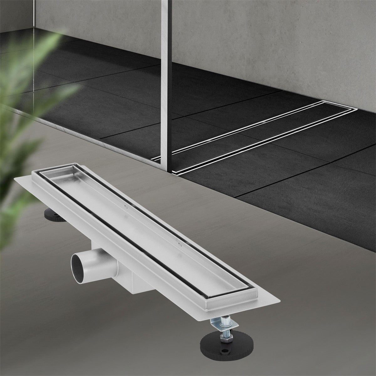A shower drain in a modern bathroom with gray tiles.