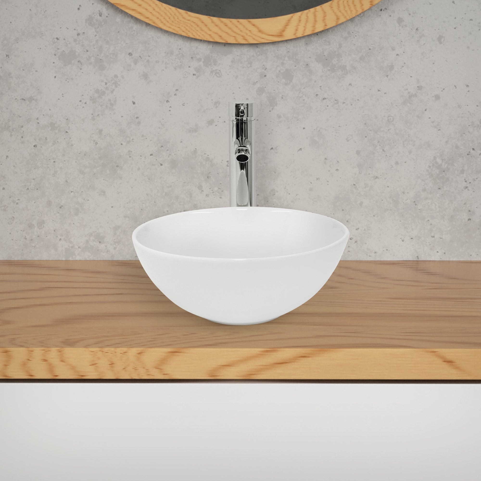 Round, white sink on a wooden cabinet with a mirror in the background.