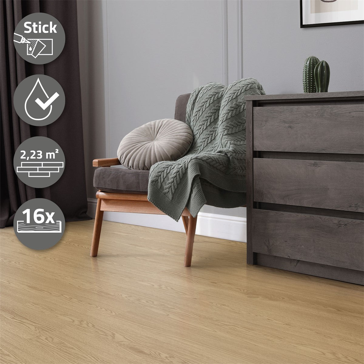 An armchair with a blanket, a cushion, and a cabinet in a room.