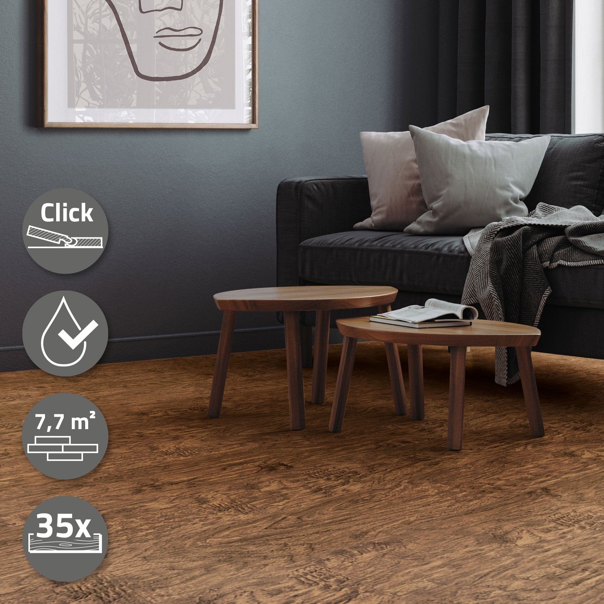 Zwei kleine Holztische auf einem dunklen Boden vor einer Couch mit Kissen.