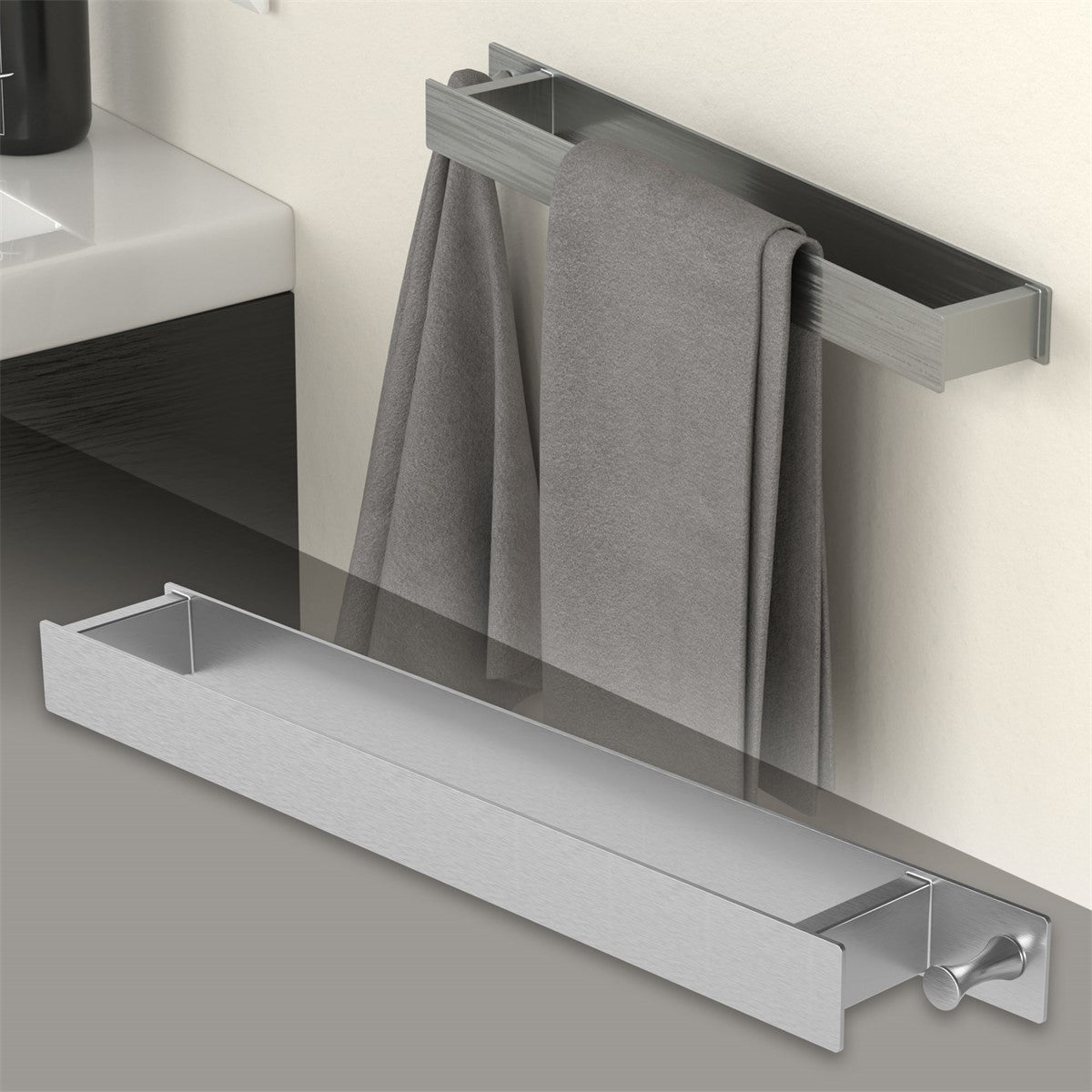 Silver towel holder with two towels, mounted on a wall.