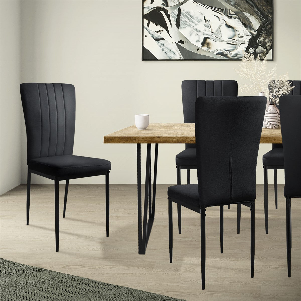 Dining room with a table and several black chairs.