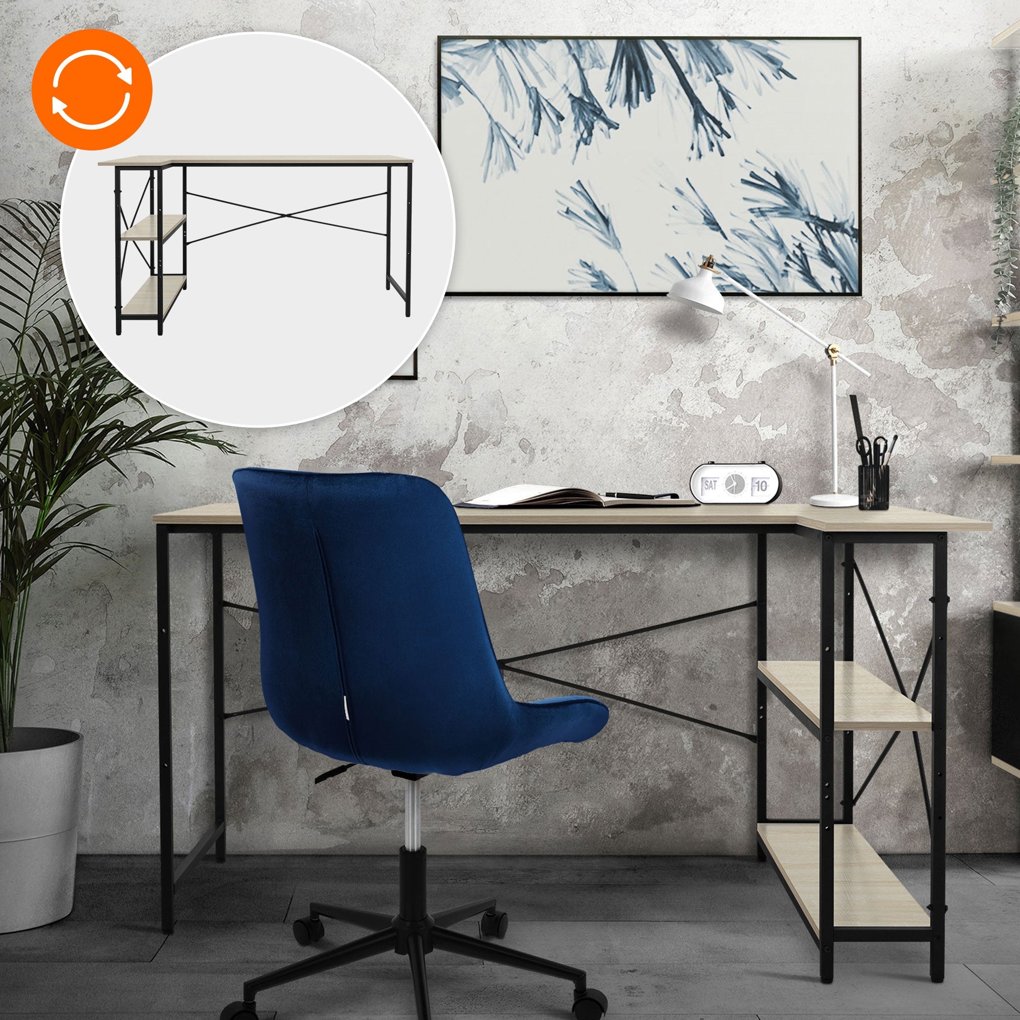 Desk with a computer, a lamp, and plants, in front of a wall with art.