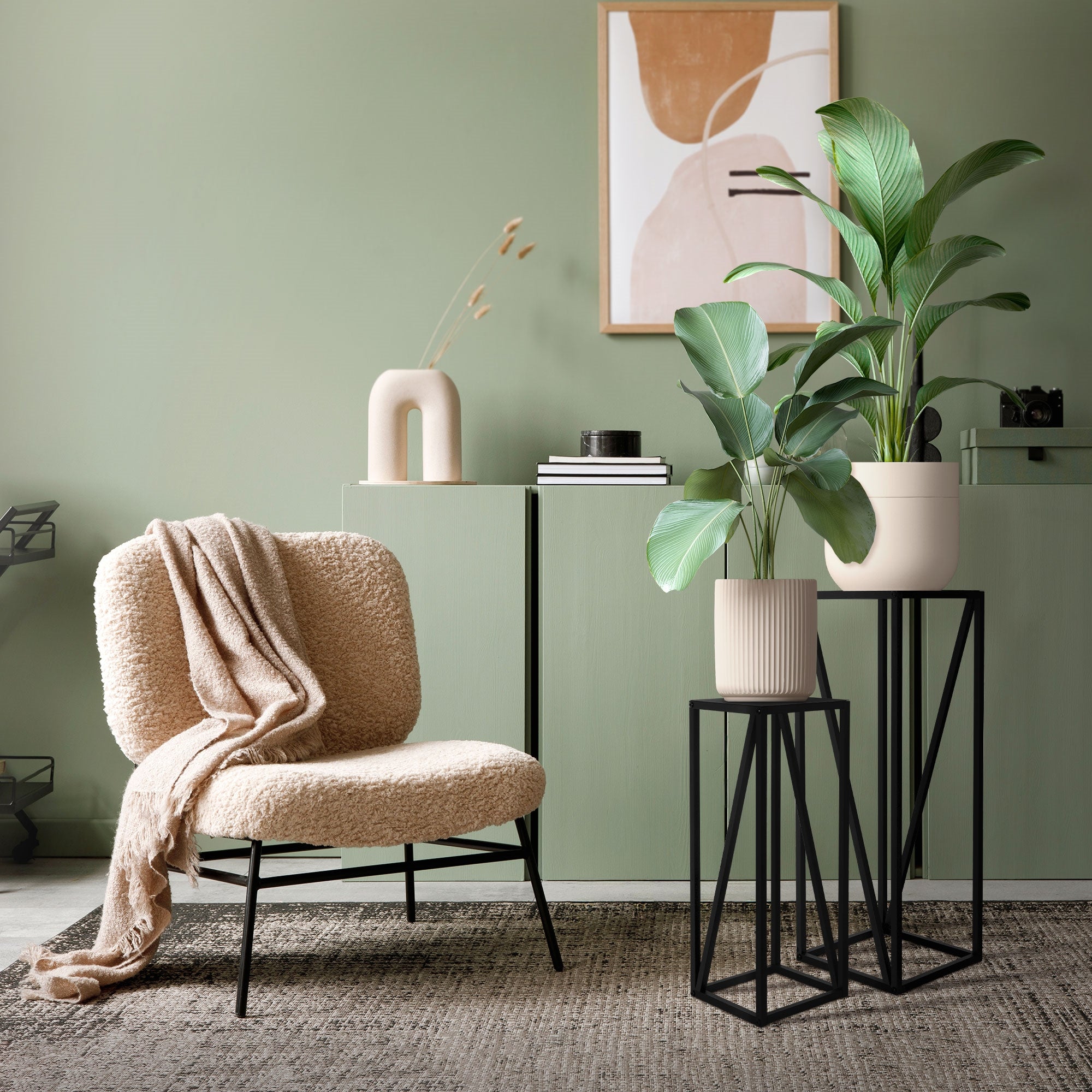 A cozy armchair next to a table with plants and decoration in a modern room.