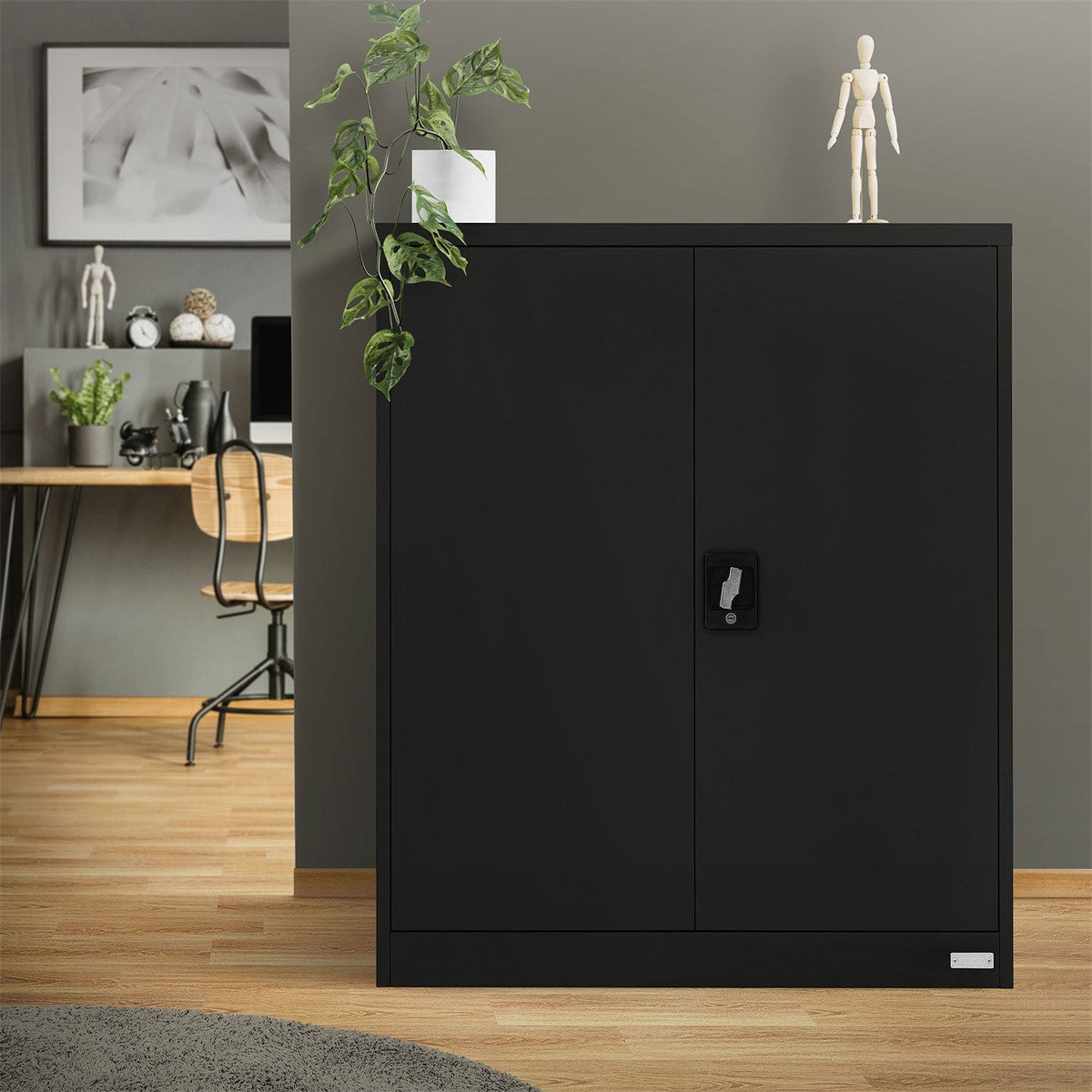 Black filing cabinet in a room with plants and a desk.