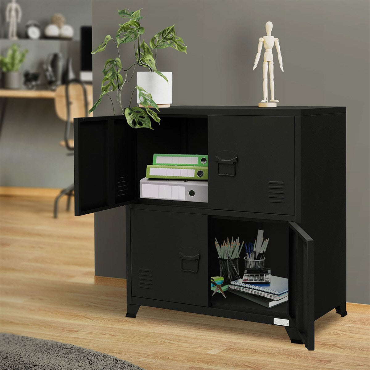 An open black cabinet with plants and office supplies on a wooden floor.