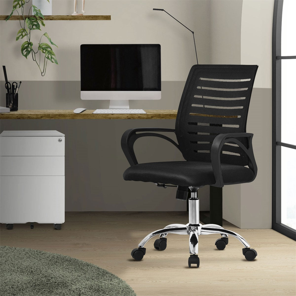 Office chair in a modern work environment, with a computer and desk visible.