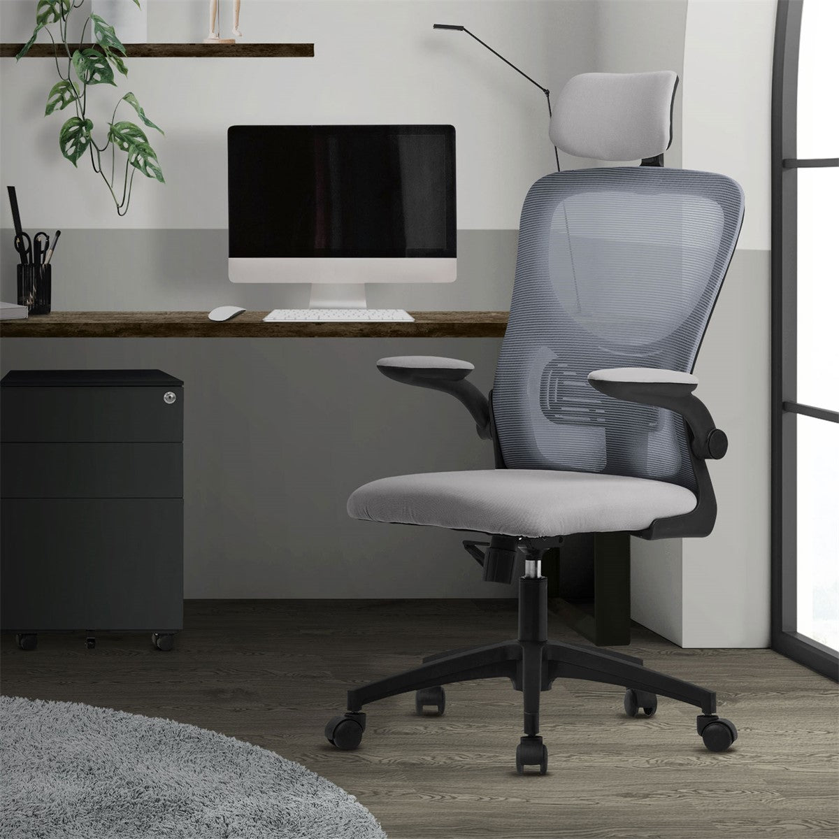 Office chair in a modern office with a computer and plants in the background.