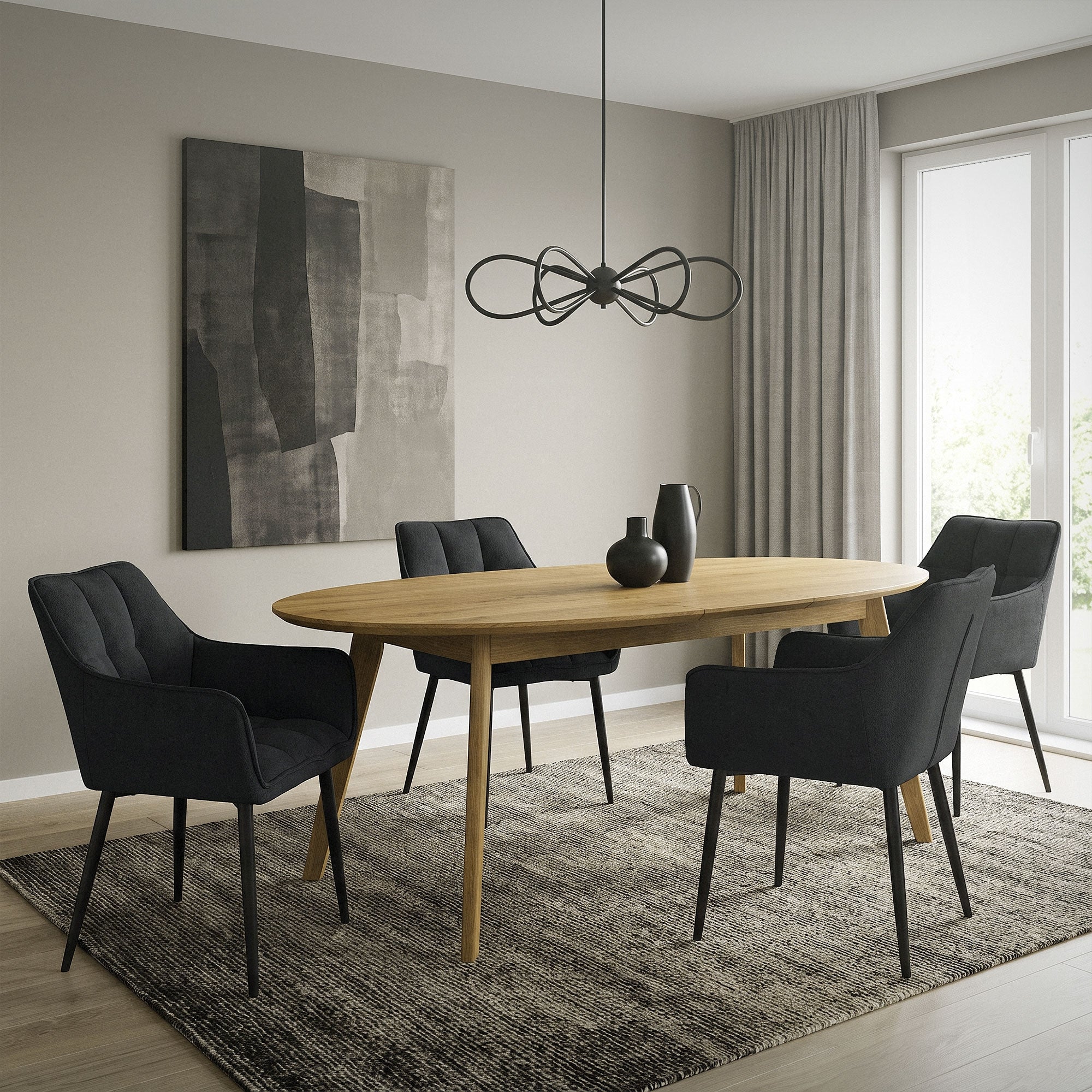 Dining room with an oval wooden table and four black chairs on a carpet.