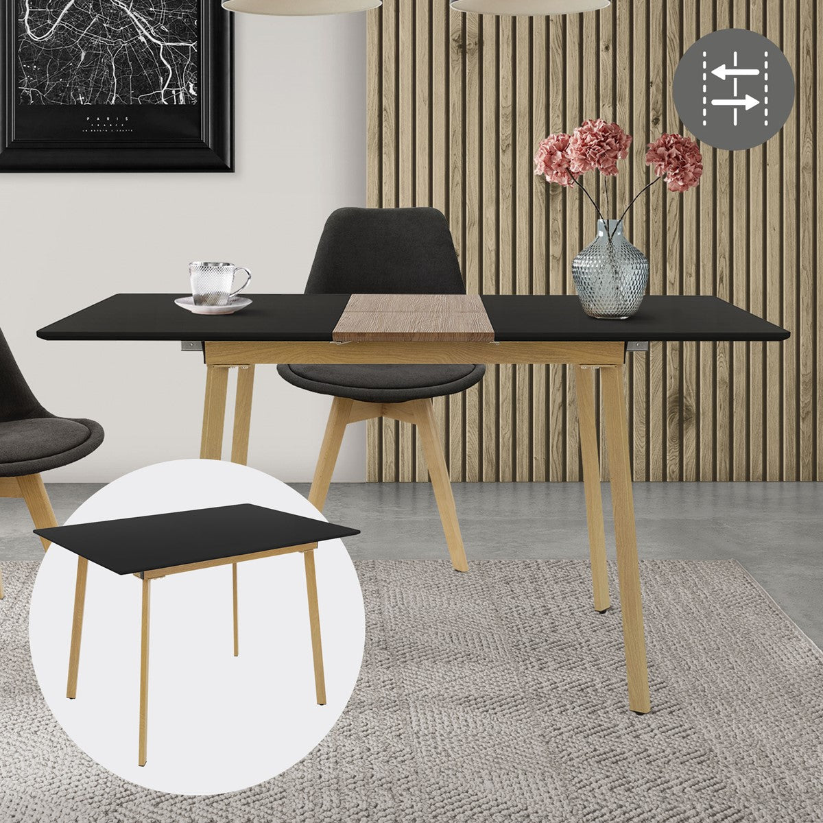 A black table with wooden legs, a vase of flowers and a glass on a table runner.