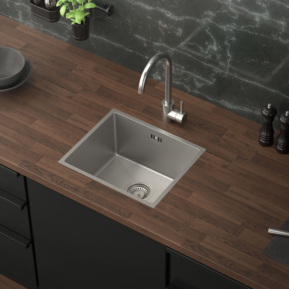 Kitchen worktop with a stainless steel sink and faucet.