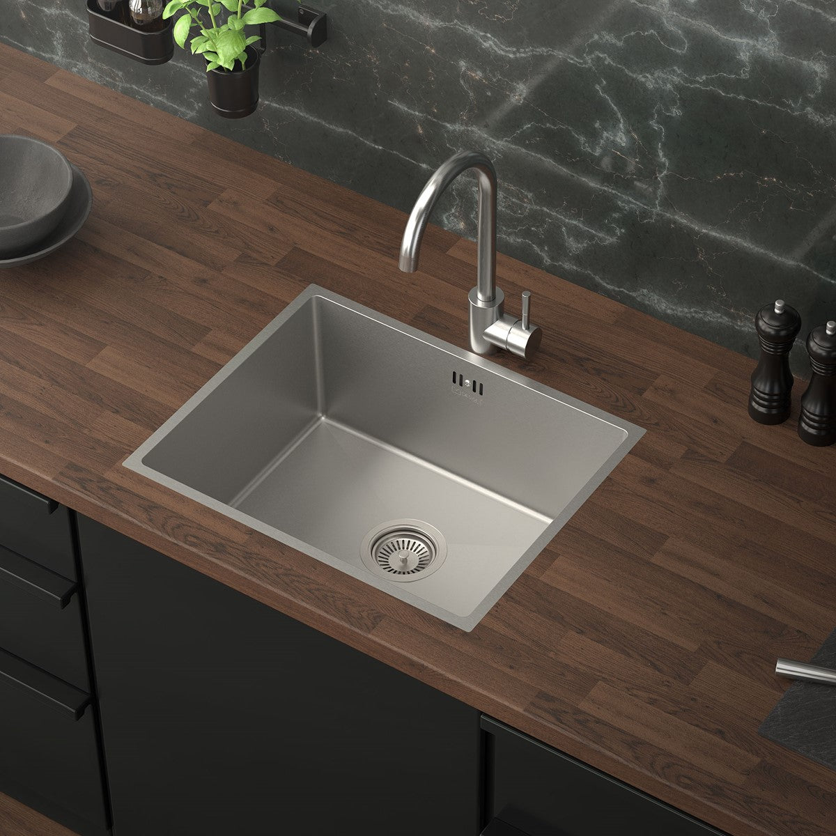 Top view of a stainless steel sink on a wooden surface with a faucet.
