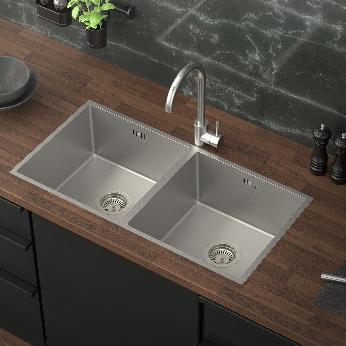 Double stainless steel sink on a wooden worktop.
