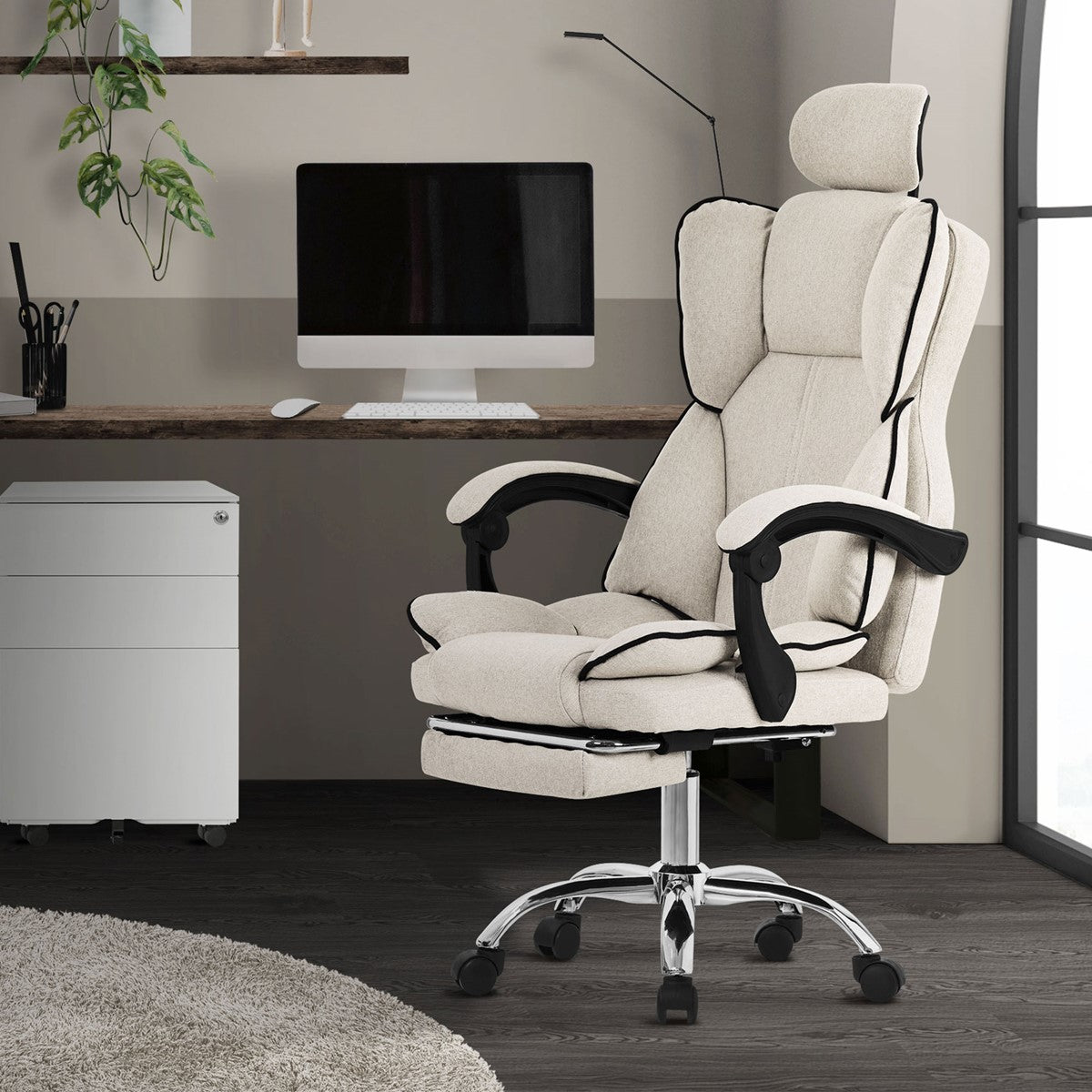 Office chair in a modern work environment with a computer and plants.