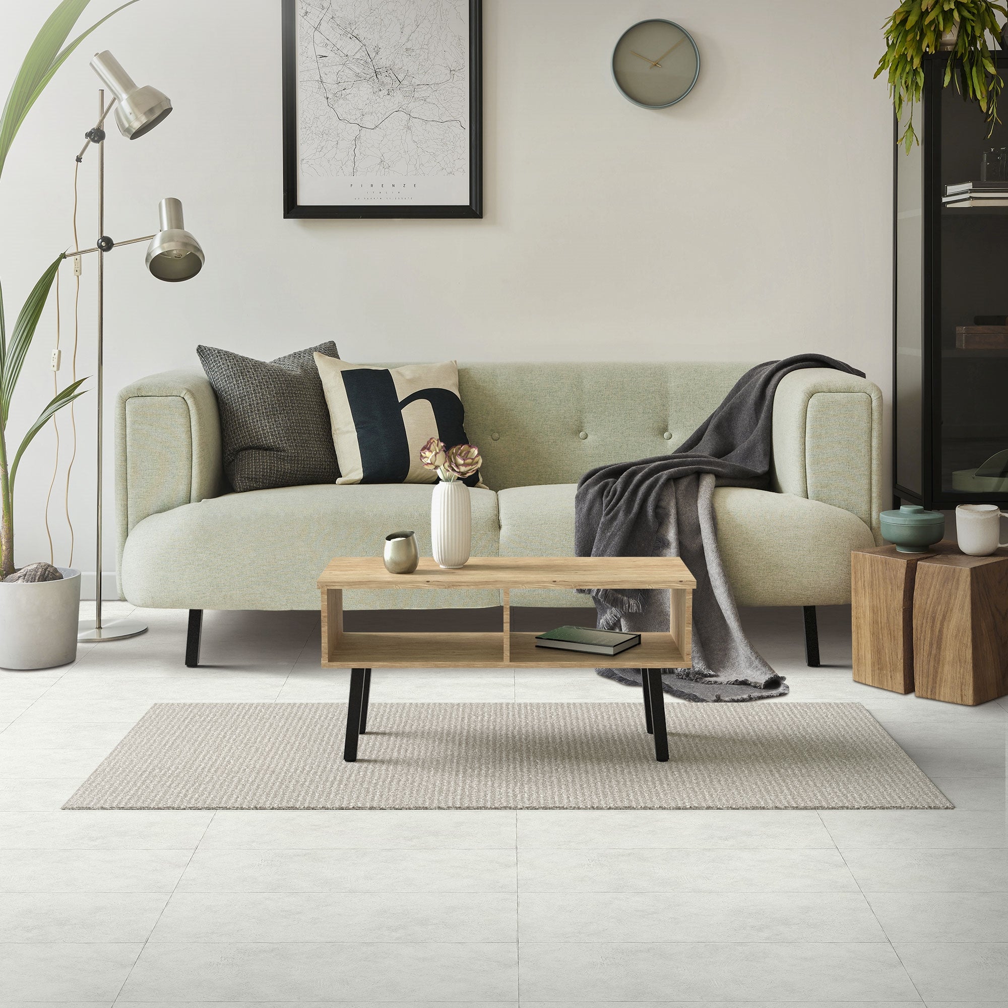 A modern living room with a sofa, a coffee table, and a floor lamp.