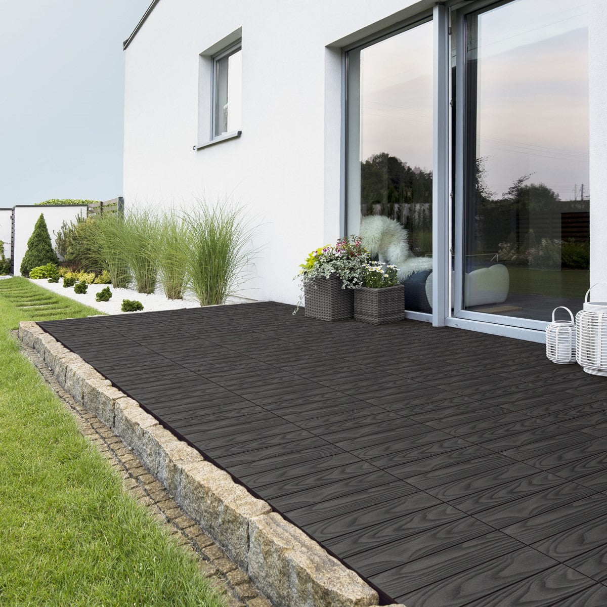 Terraço com ladrilhos assentados e plantas.