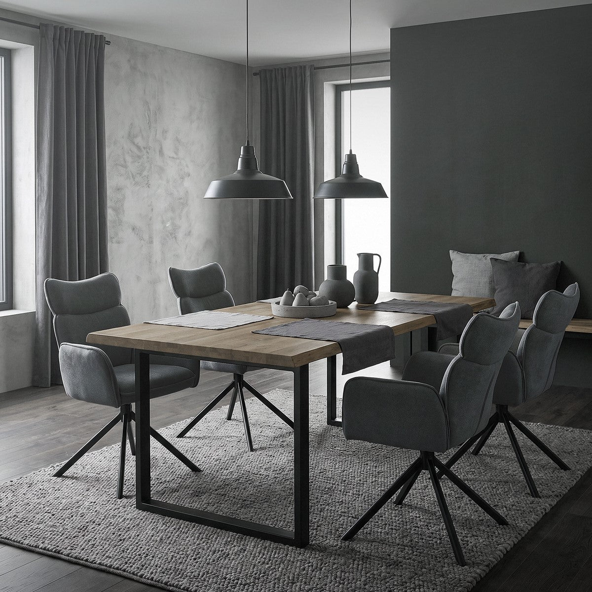 A modern dining area with gray chairs and a wooden table.