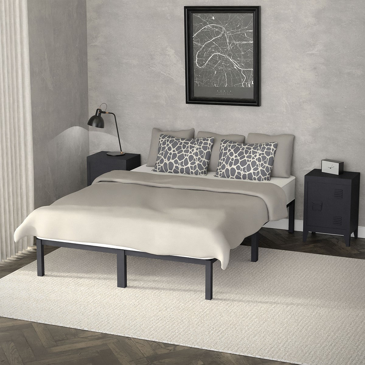 Double bed with beige bedding, two patterned pillows, and a black frame in a gray bedroom.