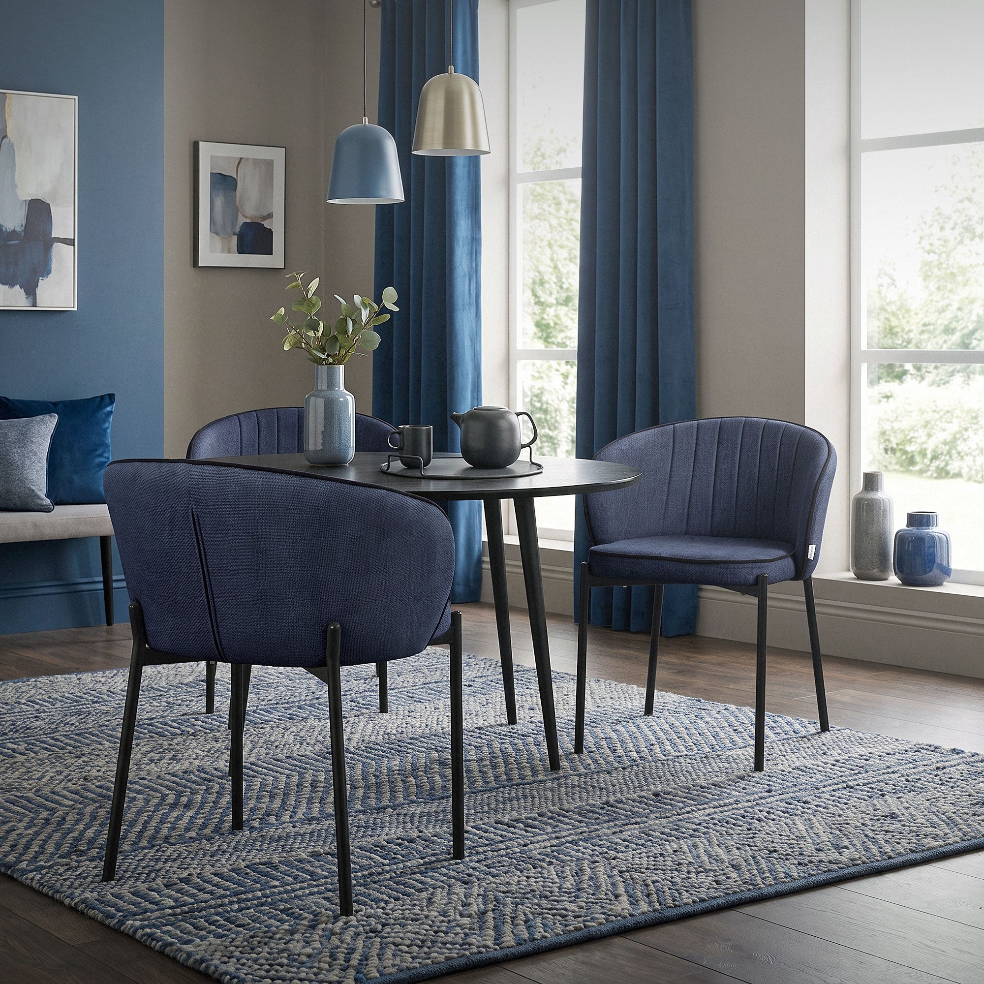 Blue chair at a table in a bright dining room.
