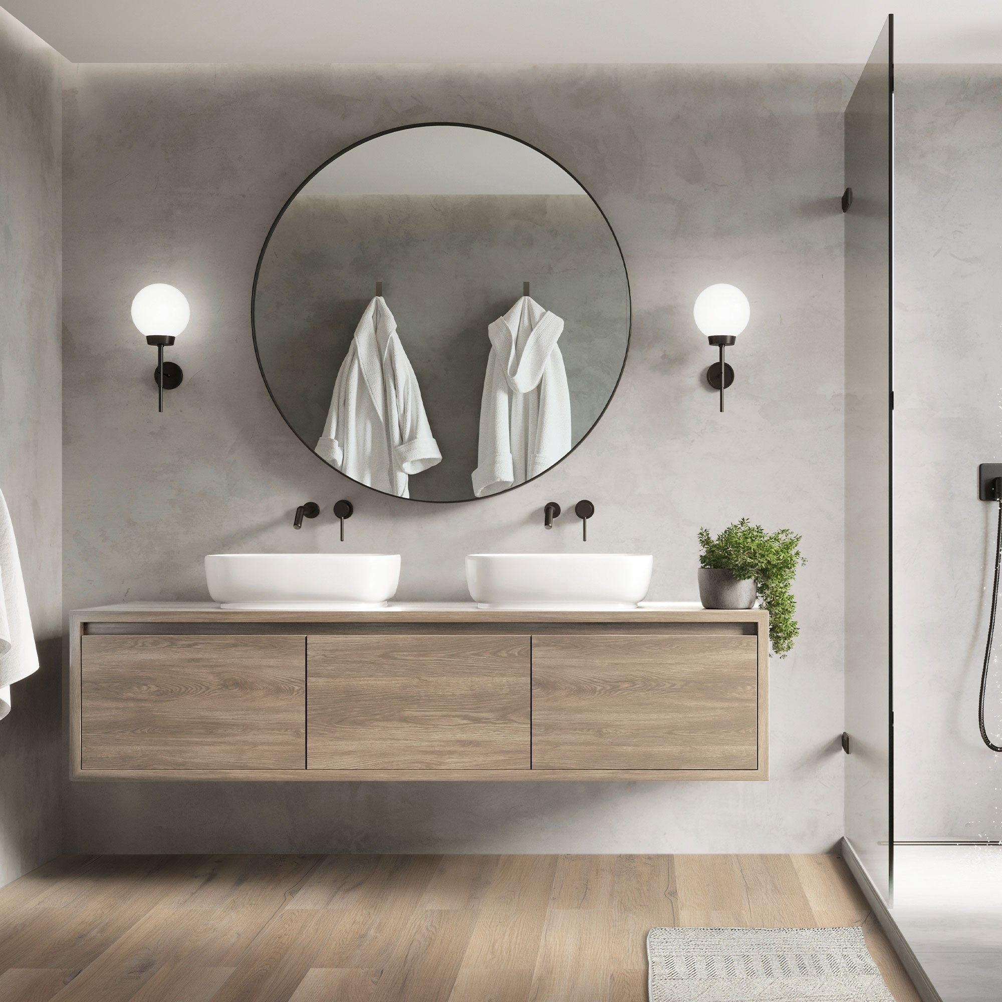 Modernes Badezimmer mit zwei Waschbecken und runder Spiegel.