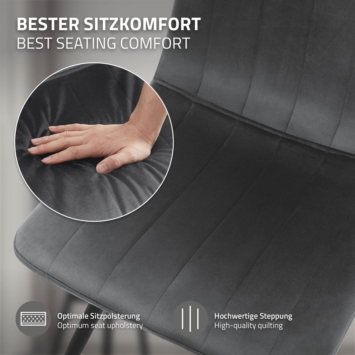 Close-up van een donkergrijs stoeloppervlak met sierstiksels; een hand drukt op de bekleding. Informatie over de zittingvulling en het stiksel.