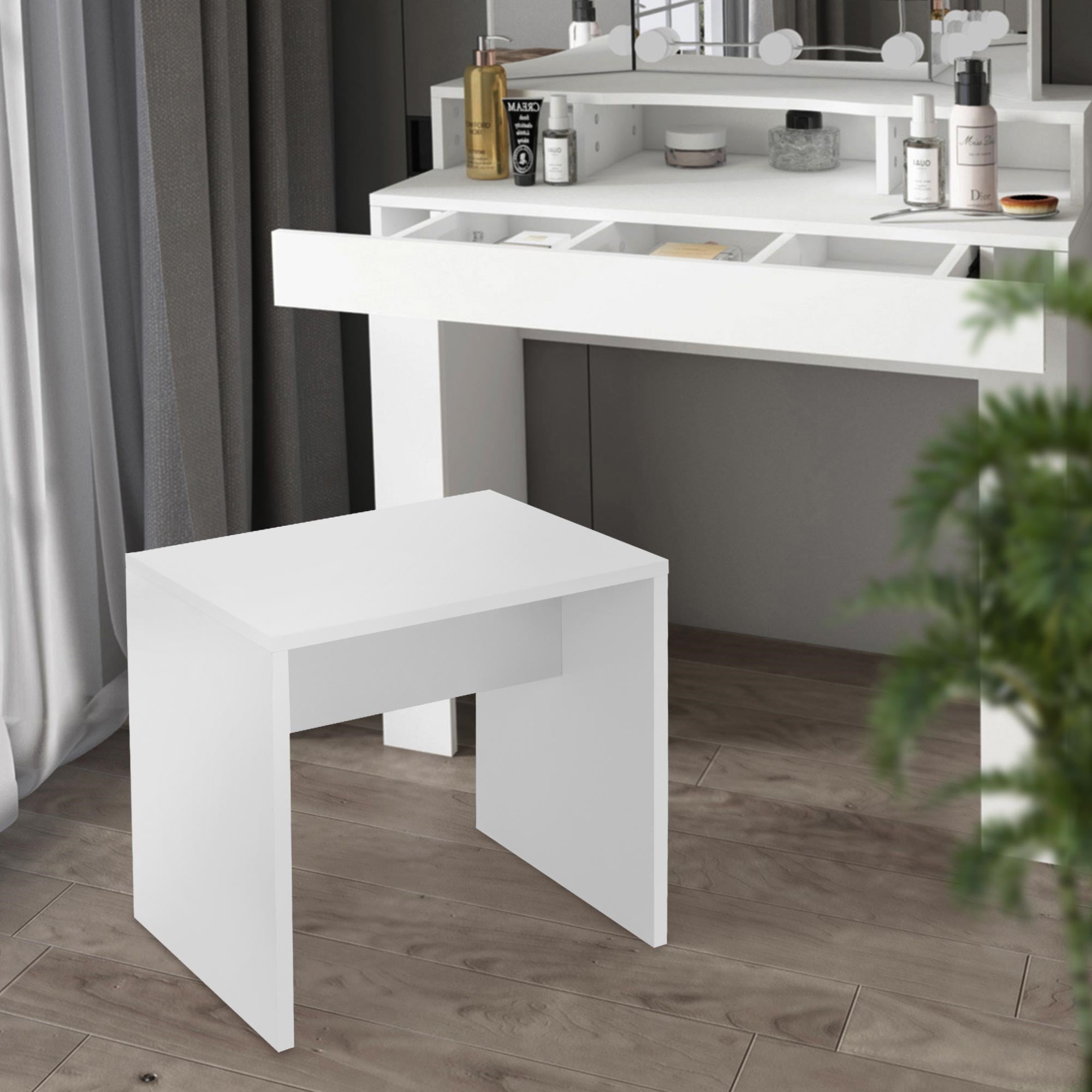 White table in front of a vanity with cosmetics.