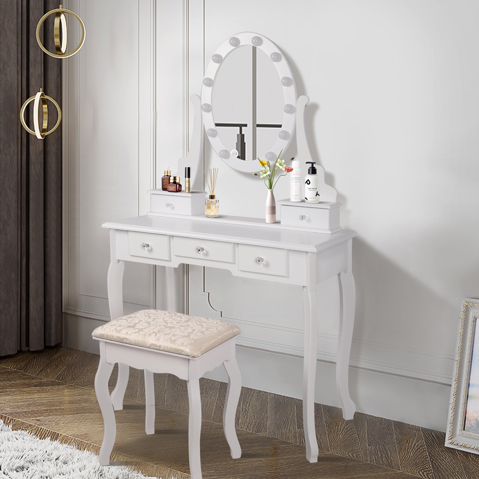 White dressing table with mirror, three drawers, and a stool.