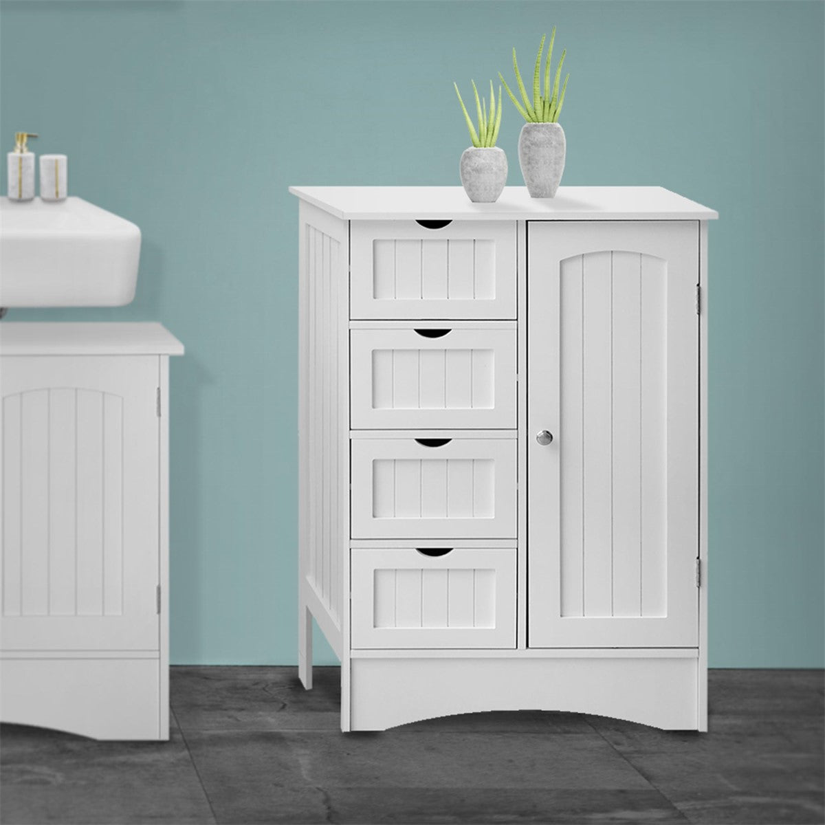 A white cabinet with drawers and two vases on top.