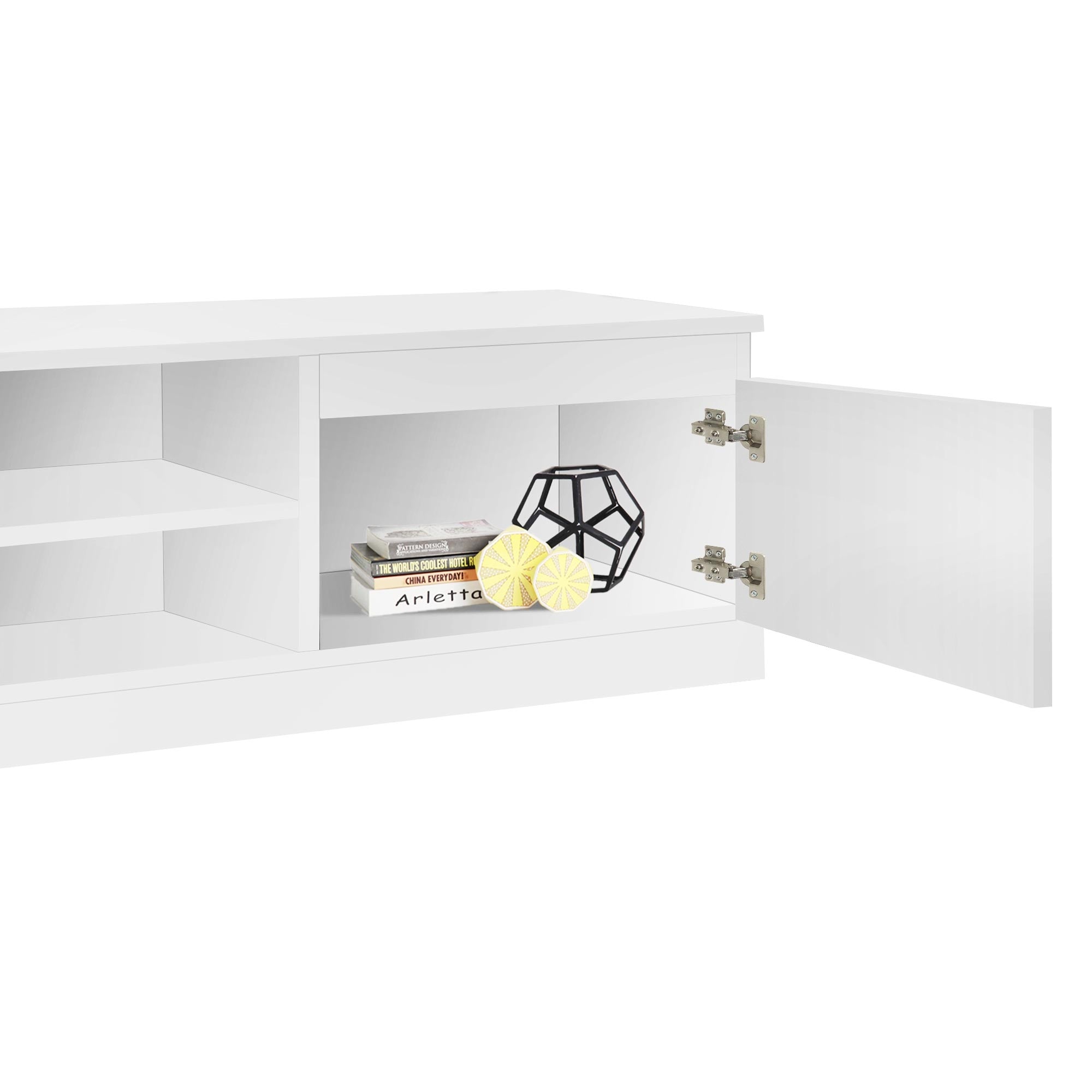 Un mobile bianco con cassetto aperto, decorato con un vaso geometrico e due piante.